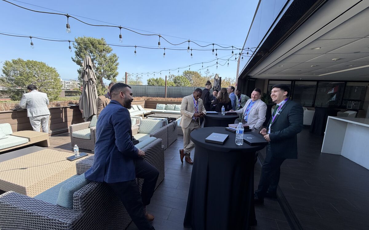 Noble Summit Management professionals networking at a rooftop event